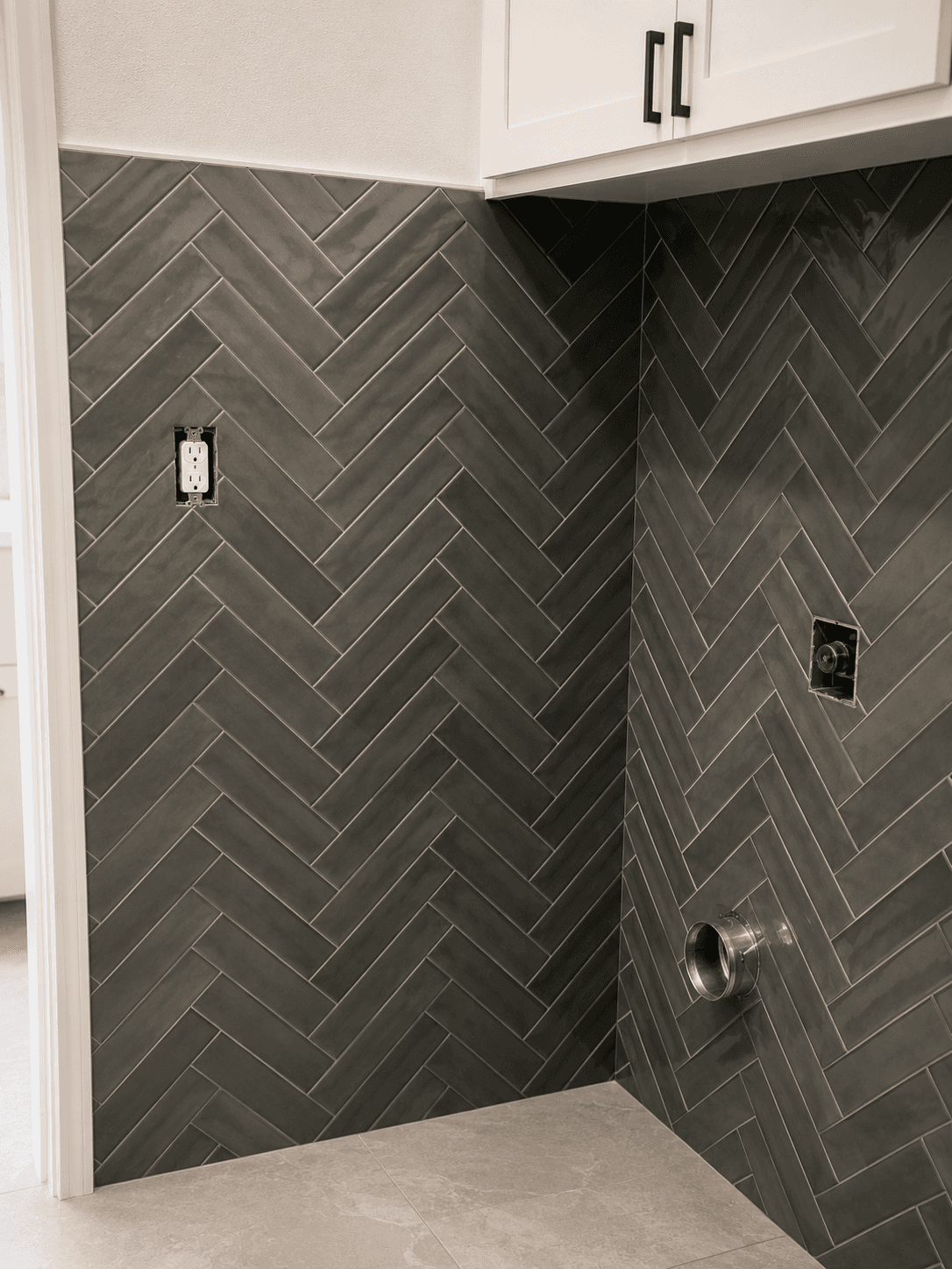 Modern utility alcove with herringbone tiles